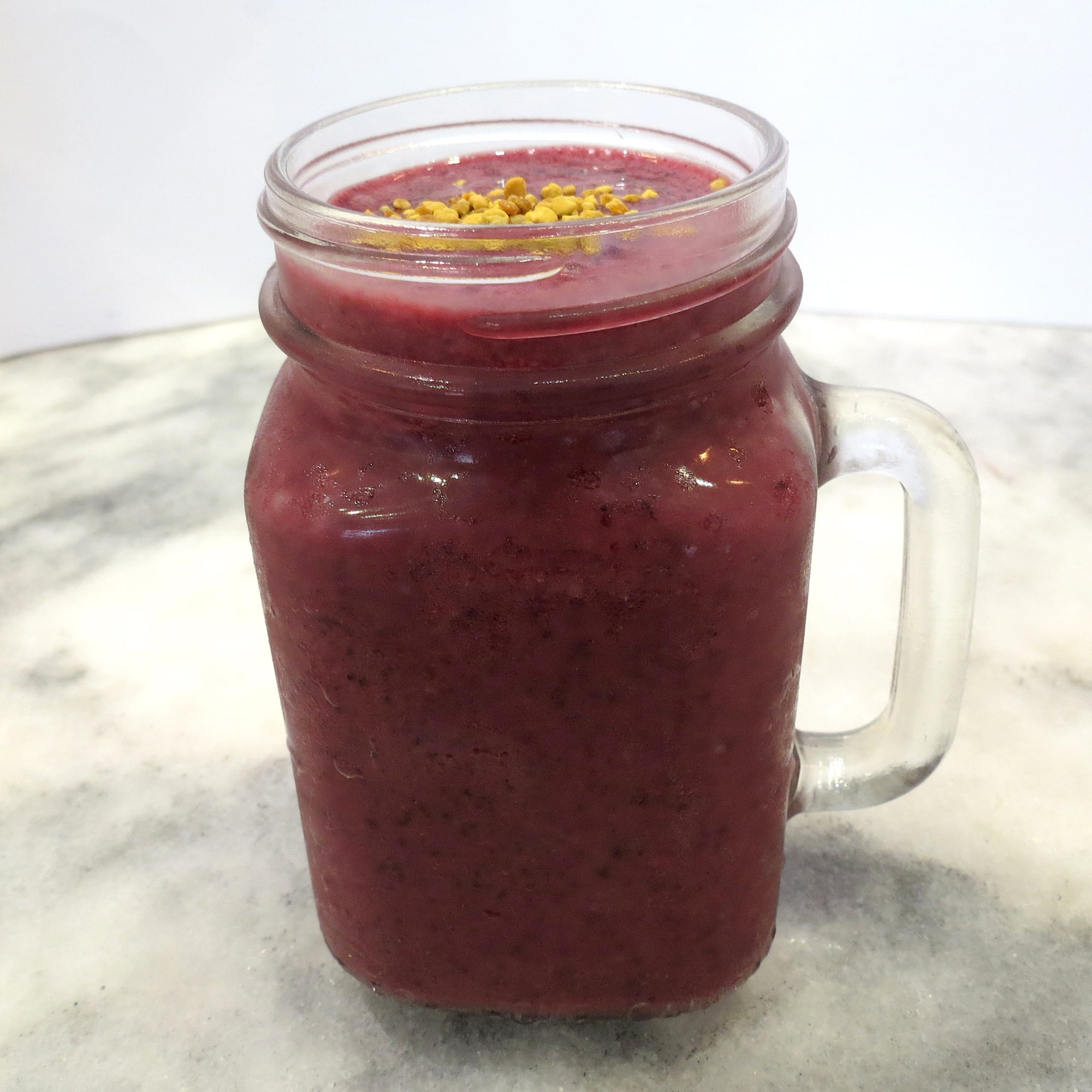 SpaJuiceBar's Cupu Acai smoothie is made with cupuacu, organic acai, wild blueberry, banana, organic apple juice served 16oz Topped with bee pollen